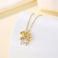 Detailed view of 18K gold bow necklace with a square cubic zirconia pendant - Gold