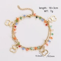 Detail view of double-layer gold chain bracelet with colorful beads and bear charms - Hollow Bear