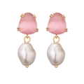 Macro detail of gold earrings featuring pink gemstones and irregular baroque pearls - Pink