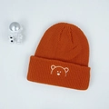 Detail of orange ribbed knit baby hat featuring a minimalist bear head embroidery - 44-54cm / Orange