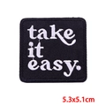Square black embroidered patch featuring white 'take it easy.' text and stitched edges - take it easy