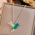 Close-up of enamel hummingbird pendant necklace in teal and yellow on a brown display box - Enamel Hummingbird Pendant Necklace-Silver Chain (20)