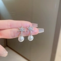 Detail of silver snowflake earring with inlaid crystals and a dangling white pearl - #12 Silver Zirconia Snowflake Pearl
