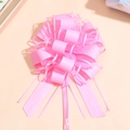 Close-up of pink ribbon pull bow made of sheer organza and satin for gift wrapping - Pink