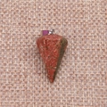 Macro detail of faceted teardrop crystal pendant in red and green stone with silver clasp - Unakite