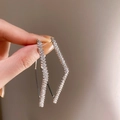 Silver twist rectangular earrings with sparkling diamonds held by a hand - Silver (925 Sterling Silver Earring Post)