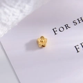 Macro shot of gold floral spacer bead with matte finish for DIY jewelry making - Type E - Small Flower Shape