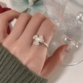 Silver flower ring with white pearl center on textured band worn by hand model - Silver Flower White Bead Ring (J4984)