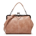 Close-up of brown leather handbag with metal frame clasp and detachable shoulder strap - Apricot