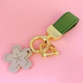 Cute pink leather cherry blossom keychain with green strap and gold metal hardware - Green Leather [Cherry Blossom]