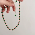 Colorful beaded necklace with green round beads and red-white striped cylinder beads - Brown-Green Beaded Necklace