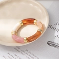 Detail of colorful acrylic tube bracelet with marble pattern and gold metal ring connectors - Light Mixed Color