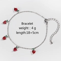 Silver strawberry charm bracelet featuring red cubic zirconia and green leaf accents - Silver Strawberry Bracelet