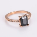 Detail of rose gold ring with a rectangular black gemstone and side diamond accents - US 7 / Rose Gold / Black Zirconia