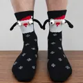 Detail of 3D Santa Claus socks with magnetic hands and festive snowflake patterns - Black Santa Snowflake