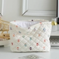 Quilted white cosmetic bag with colorful cartoon prints and silver zipper closure - Cartoon Character