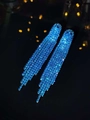 Macro detail of luxury long tassel earrings with sparkling blue rhinestones and fringe - 3D Style / Lake Blue
