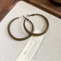 Close-up of army green enamel geometric hoop earrings on a beige fabric and wooden tray - 5cm (Silver Needle) / Olive Green