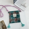 Detail of vintage plaid mini crossbody bag with colorful woven strap and blue tassels - Green