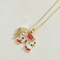 Macro detail of elephant pendant with 14K gold plating, enamel, and zircon inlays - White Elephant