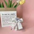 Silver organza gift bag with ribbon bow containing small bottles on pink background - 9*12cm / Light Gray