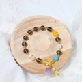 Detail of beaded bracelet with heart pendant on a round solid wood jewelry display tray - Natural Wood Round (10cm)