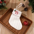 White cable knit Christmas stocking with red embroidered letter B and holly berry detail - Letter B