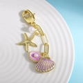 Portachiavi oceano dorato con ciondolo a conchiglia smaltata e stella marina su piatto - Viola