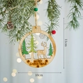 Rustic wooden Christmas tree ornament featuring a reindeer and green pines cutout - Christmas Reindeer