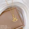 Close-up of golden balloon dog necklace on rocking base with zircons and dimensions - Balloon Dog Rocking Horse Style (E440)