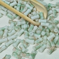 Detail of 6x12mm cylindrical bamboo-shaped ceramic beads with green marble texture - Green Khaki (White Green Brown)