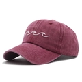 Close-up of vintage washed burgundy cotton baseball cap with white wave embroidery - Red