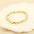 Detailed shot of golden beaded bracelet with geometric charms on a white ceramic tray - BR1683-B/Gold Round & Rhombus Beads