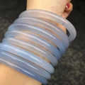 Close-up of multiple light blue Brazilian agate chalcedony bangles on a wrist - 6mm Round Bangle Style / Inner Diameter 54-55mm / Sky Blue