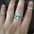 Detailed view of silver and gold hug rings with an adjustable open design worn on a hand - Style 004 / Antique Silver