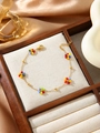 Detail of colorful beaded flower bracelet on a premium wooden display tray with silk background - Multicolor