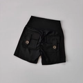 Flat lay macro detail of black high-waisted yoga shorts with side cargo pockets and buttons - S / Black