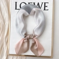Elegant geometric color-block silk scarf in grey and champagne on a display stand - 70x70cm / Triangle Patchwork-Pink Grey