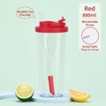 Red 880ml Tritan water bottle with retractable straw for boba tea on green background - Red