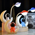 Creative astronaut moonlight LED table lamp set in white, blue, and red colors - Moon Astronaut Style