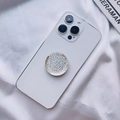 Silver sequin glitter round phone socket holder attached to a white smartphone back - Expanding Stand / Dotted Laser Round