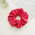 Detail of red fabric scrunchie with bow on a minimalist desk with book and glass - Basic Style / Rose Red