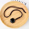 Faceted black obsidian teardrop pendant on adjustable braided cord over wood plate - 2.5cm Hexagram Obsidian Pendant