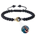 Macro detail of 6mm tiger eye photo projection bracelet with adjustable black cord - Matte Stone Bracelet