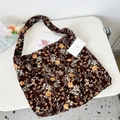 Detail showing vintage floral corduroy shoulder bag with MISS tag on a white table - Zinnia Brown