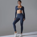 Detail view of navy blue yoga set featuring a twisted crop top and high-waisted leggings - S / Navy Blue