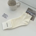 Chaussettes blanches respirantes en coton avec revers côtelés et étiquette minimaliste - Taille unique / Blanc Lait