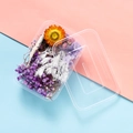 Close-up of preserved dried flower kit in a clear plastic box with assorted colorful petals - Aubrieta Purple