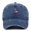 Close-up of pink flamingo embroidery and distressed texture on washed denim baseball cap - Adjustable / Navy Blue