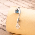 Silver titanium steel navel ring featuring blue gemstones and clear teardrop pendant - Blue + White (Right)